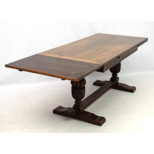 200 - An oak Jacobean style drawer leaf table and cup and cover trestle ends 30'' wide x 60 1/2'' (unexten... 