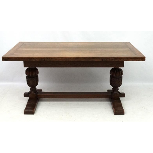 200 - An oak Jacobean style drawer leaf table and cup and cover trestle ends 30'' wide x 60 1/2'' (unexten... 