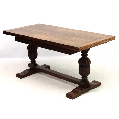 200 - An oak Jacobean style drawer leaf table and cup and cover trestle ends 30'' wide x 60 1/2'' (unexten... 