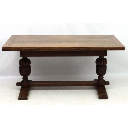 200 - An oak Jacobean style drawer leaf table and cup and cover trestle ends 30'' wide x 60 1/2'' (unexten... 