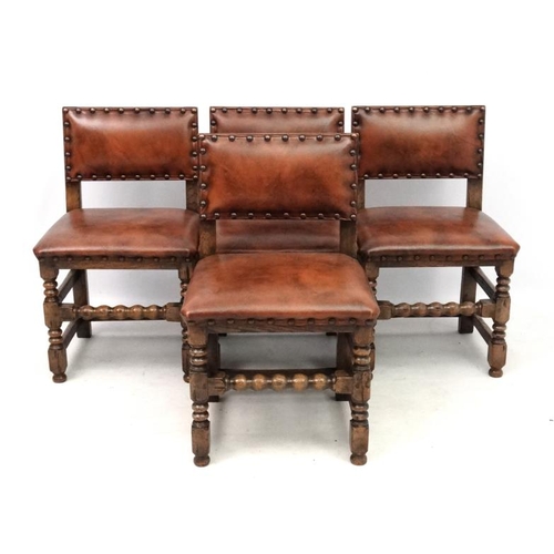 201 - Four early 20thC oak dining chairs with later upholstery with brass stud detail.