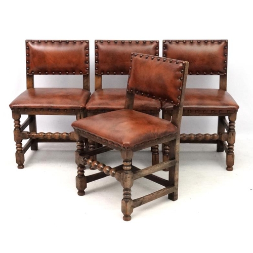 201 - Four early 20thC oak dining chairs with later upholstery with brass stud detail.