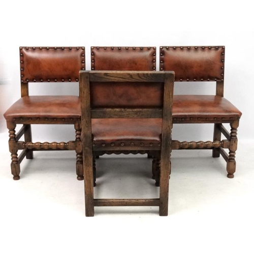 201 - Four early 20thC oak dining chairs with later upholstery with brass stud detail.