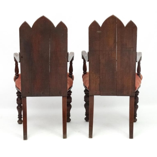 206 - Arts and Crafts :  A pair of 19thC Gothic Oak open armchairs , having three lancet  shaped panels to... 