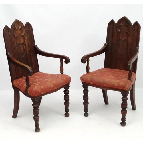 206 - Arts and Crafts :  A pair of 19thC Gothic Oak open armchairs , having three lancet  shaped panels to... 