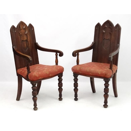 206 - Arts and Crafts :  A pair of 19thC Gothic Oak open armchairs , having three lancet  shaped panels to... 