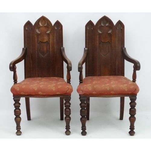 206 - Arts and Crafts :  A pair of 19thC Gothic Oak open armchairs , having three lancet  shaped panels to... 