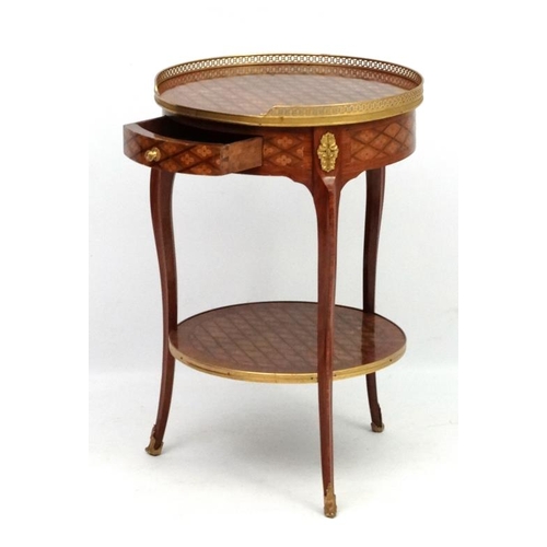 207 - A late 19thC / early 20thC French marquetry 2-tier circular centre table / etage with ormolu gallery... 