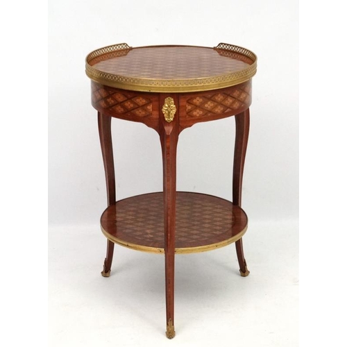 207 - A late 19thC / early 20thC French marquetry 2-tier circular centre table / etage with ormolu gallery... 