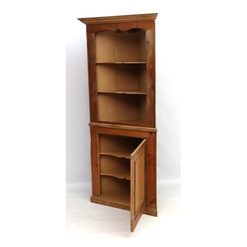 211 - A 19thC pine corner cupboard with three open shelves and panelled cupboard door under 35 1/2'' wide ... 