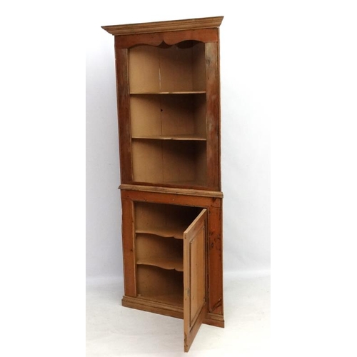 211 - A 19thC pine corner cupboard with three open shelves and panelled cupboard door under 35 1/2'' wide ... 