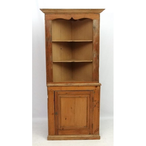 211 - A 19thC pine corner cupboard with three open shelves and panelled cupboard door under 35 1/2'' wide ... 