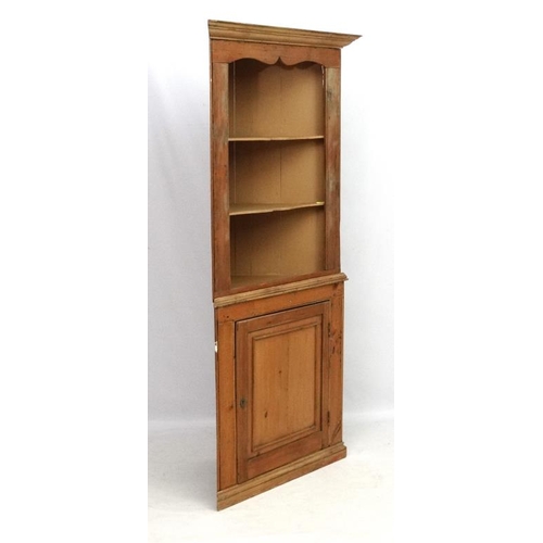 211 - A 19thC pine corner cupboard with three open shelves and panelled cupboard door under 35 1/2'' wide ... 