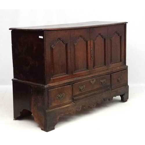 217 - An early 18thC oak four panelled mule chest with 3 drawers under ( the central 2 panels now opening ... 