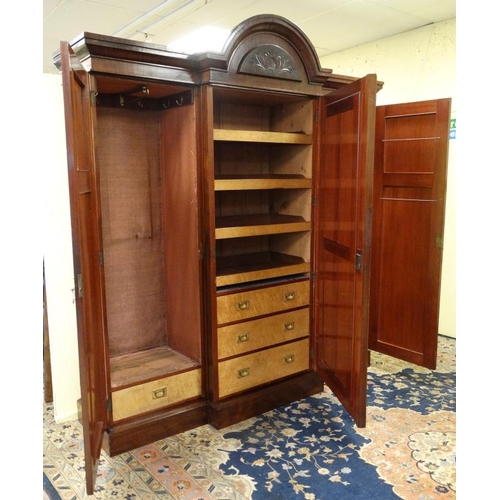 219 - A 19thC mahogany breakfront triple wardrobe with central section with drawers and linen sides 94'' h... 