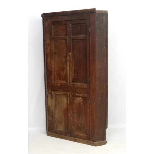 221 - A Georgian oak floor standing corner cabinet with green painted interior. Approx. 84 1/2'' high