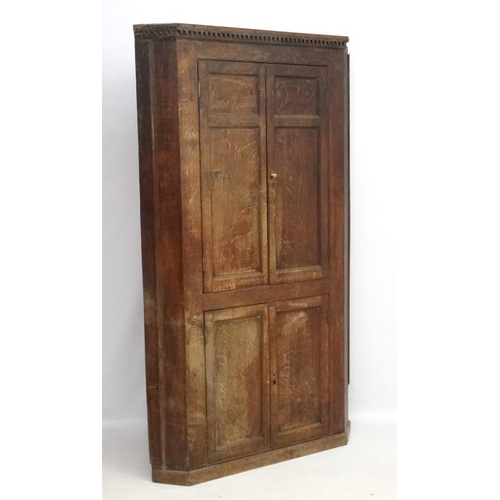 221 - A Georgian oak floor standing corner cabinet with green painted interior. Approx. 84 1/2'' high