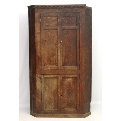 221 - A Georgian oak floor standing corner cabinet with green painted interior. Approx. 84 1/2'' high