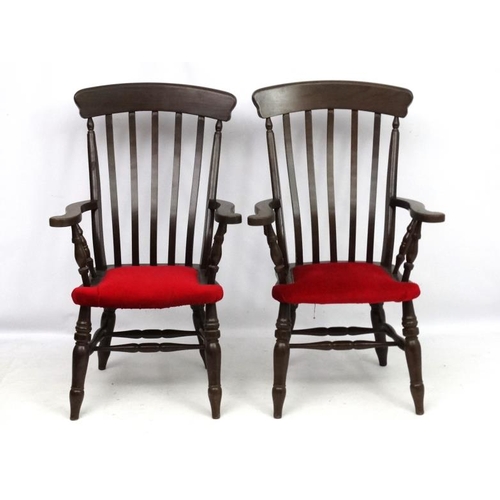 223 - A pair of mid 20thC lathe back armchairs with upholstery to seat and double stretchers 44 1/2'' high