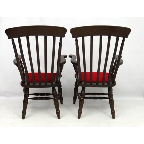 223 - A pair of mid 20thC lathe back armchairs with upholstery to seat and double stretchers 44 1/2'' high