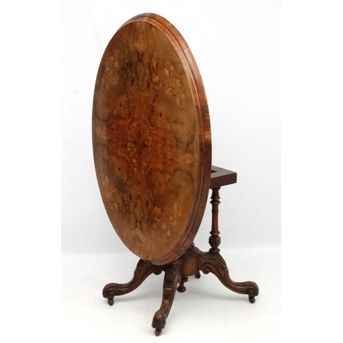 227 - A Victorian inlaid walnut oval tilt top centre table 45'' long x 34'' deep x 28'' high