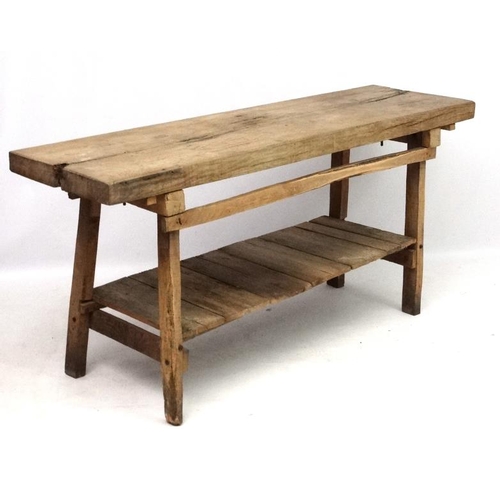 229 - A 19thC Continental oak Farmhouse kitchen block on stand with under tier shelf. 68'' long