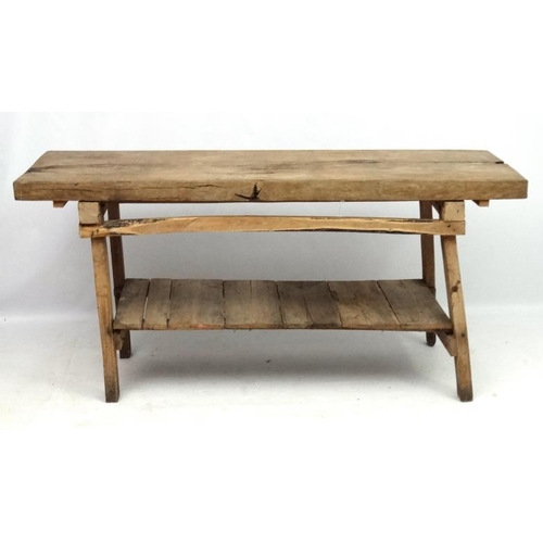 229 - A 19thC Continental oak Farmhouse kitchen block on stand with under tier shelf. 68'' long