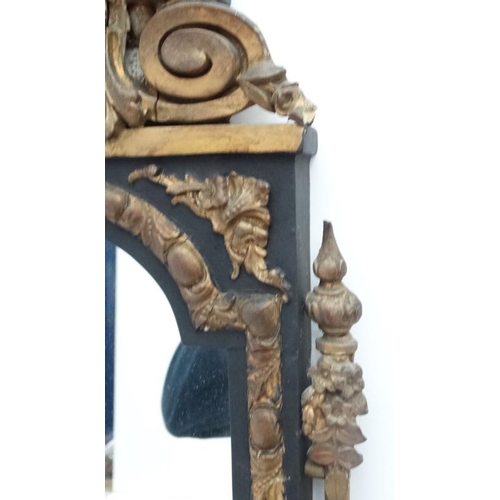 230 - A 19thC French hall mirror in the pier style with gilt and black decoration. 35'' high x 11 1/2'' wi... 