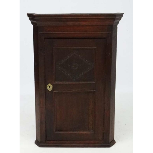 237 - An 18thC oak panelled hanging corner cupboard 42'' high