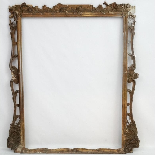 248 - Picture Frame :  an extremely  large gilt frame with pierced decoration , having the internal measur... 