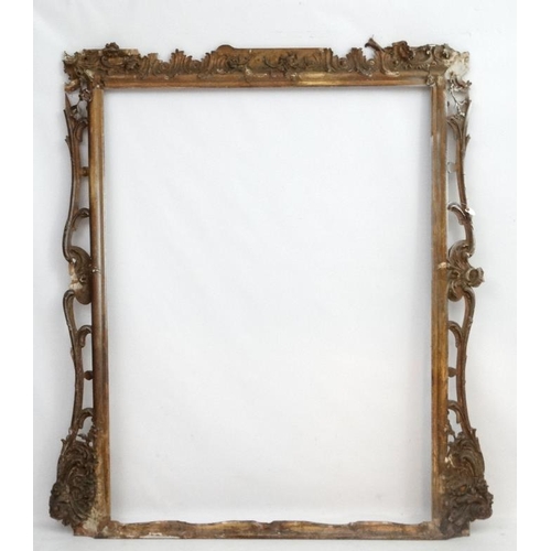 248 - Picture Frame :  an extremely  large gilt frame with pierced decoration , having the internal measur... 