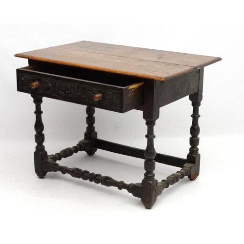 261 - An 18thC oak side table with frieze drawer ( having later carving) and turned baluster legs and supp... 