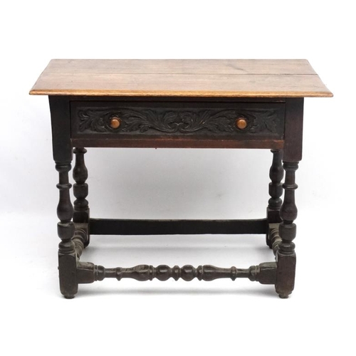 261 - An 18thC oak side table with frieze drawer ( having later carving) and turned baluster legs and supp... 