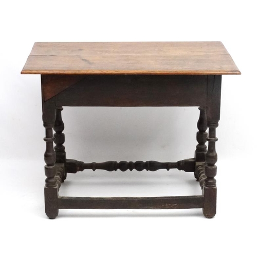 261 - An 18thC oak side table with frieze drawer ( having later carving) and turned baluster legs and supp... 