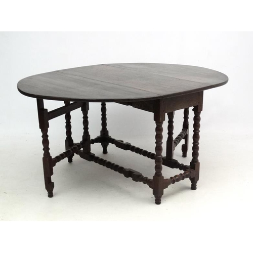 265 - A c.1900 peg jointed oak gate leg table with bobbin turned stretchers and legs etc. 46 1/2'' long x ... 