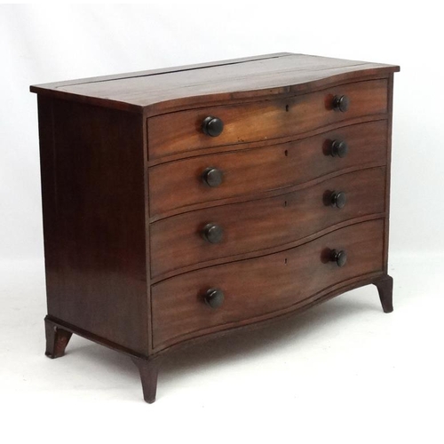 285 - Manner of Gillows : A serpentine fronted mahogany chest of drawers comprising 4 graduate long drawer... 