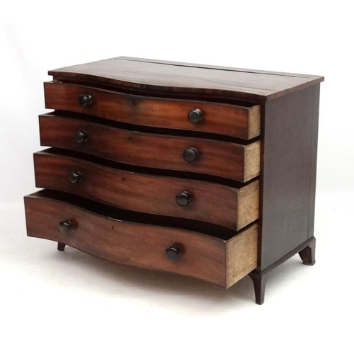 285 - Manner of Gillows : A serpentine fronted mahogany chest of drawers comprising 4 graduate long drawer... 