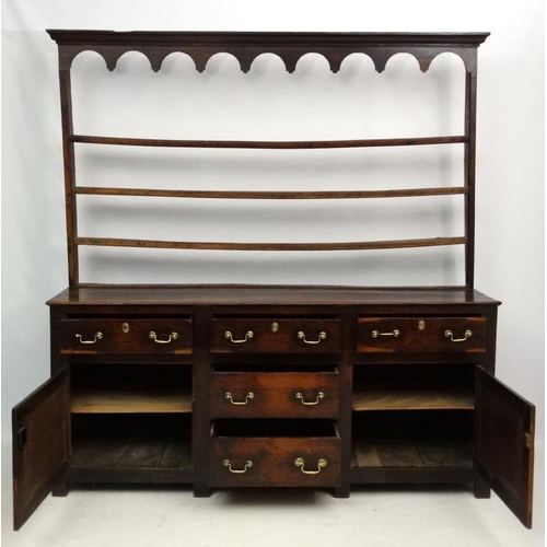 291 - An 18 thC Oak Dresser with open plate rack over five short drawers and two cupboards  79'' wide 19 1... 