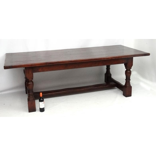 295 - A large oak 4-plank dining table in the 17thC style Refectory table with baluster turned legs and pe... 