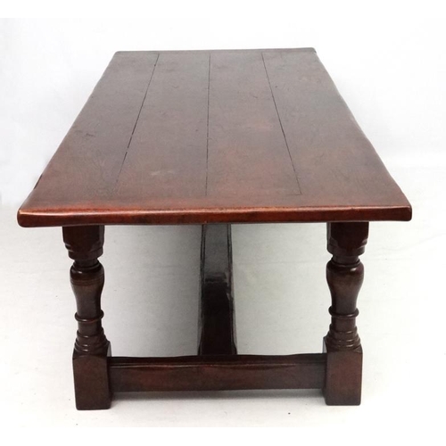 295 - A large oak 4-plank dining table in the 17thC style Refectory table with baluster turned legs and pe... 