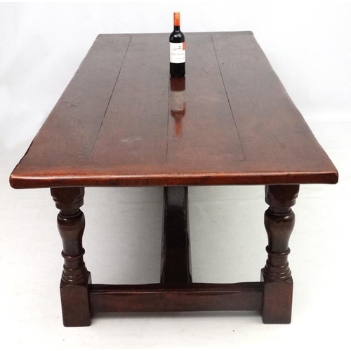 295 - A large oak 4-plank dining table in the 17thC style Refectory table with baluster turned legs and pe... 