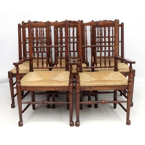 296 - A set of 8 (6+2) oak spindle back chairs with envelope rush seats . the tallest 41 1/2'' high