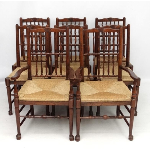 296 - A set of 8 (6+2) oak spindle back chairs with envelope rush seats . the tallest 41 1/2'' high