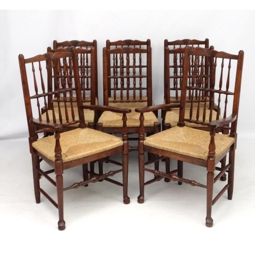 296 - A set of 8 (6+2) oak spindle back chairs with envelope rush seats . the tallest 41 1/2'' high