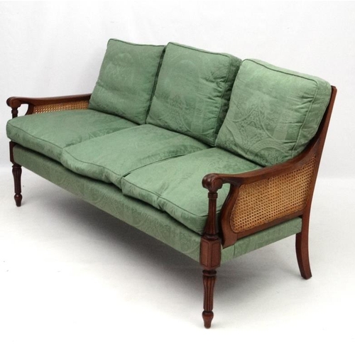 297 - Bright's of Nettlebed : A 20thC bergere suite comprising three seat sofa and 2 armchairs 35'' high