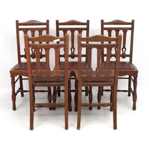 300 - A set of 4 19thC oak leather seated chairs with Arts and Crafts back splats 36 1/2'' high