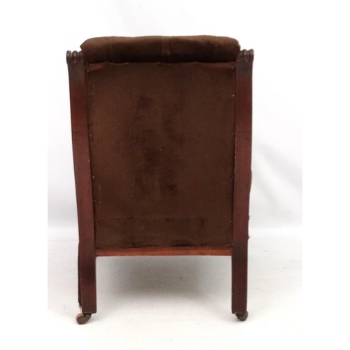 310 - A late 19thC mahogany elbow chair with button back upholstery and fluted and turned front legs. 37''... 