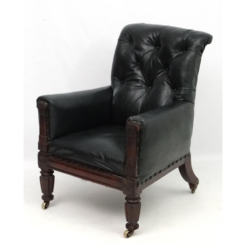 313 - Manner of Gillows : A Geo V button back arm chair with carved show wood 39'' high