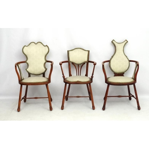 315 - Three Art Nouveau oak and elm armchairs, one marked 'JE' . Possibly  by William Birch.  The tallest ... 