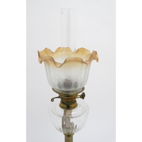 320 - Oil lamp : a c 1900 brass and glass oil lamp with circular reeded column, circular base , clear glas... 